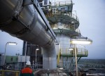 Crude settles higher but remains under pressure